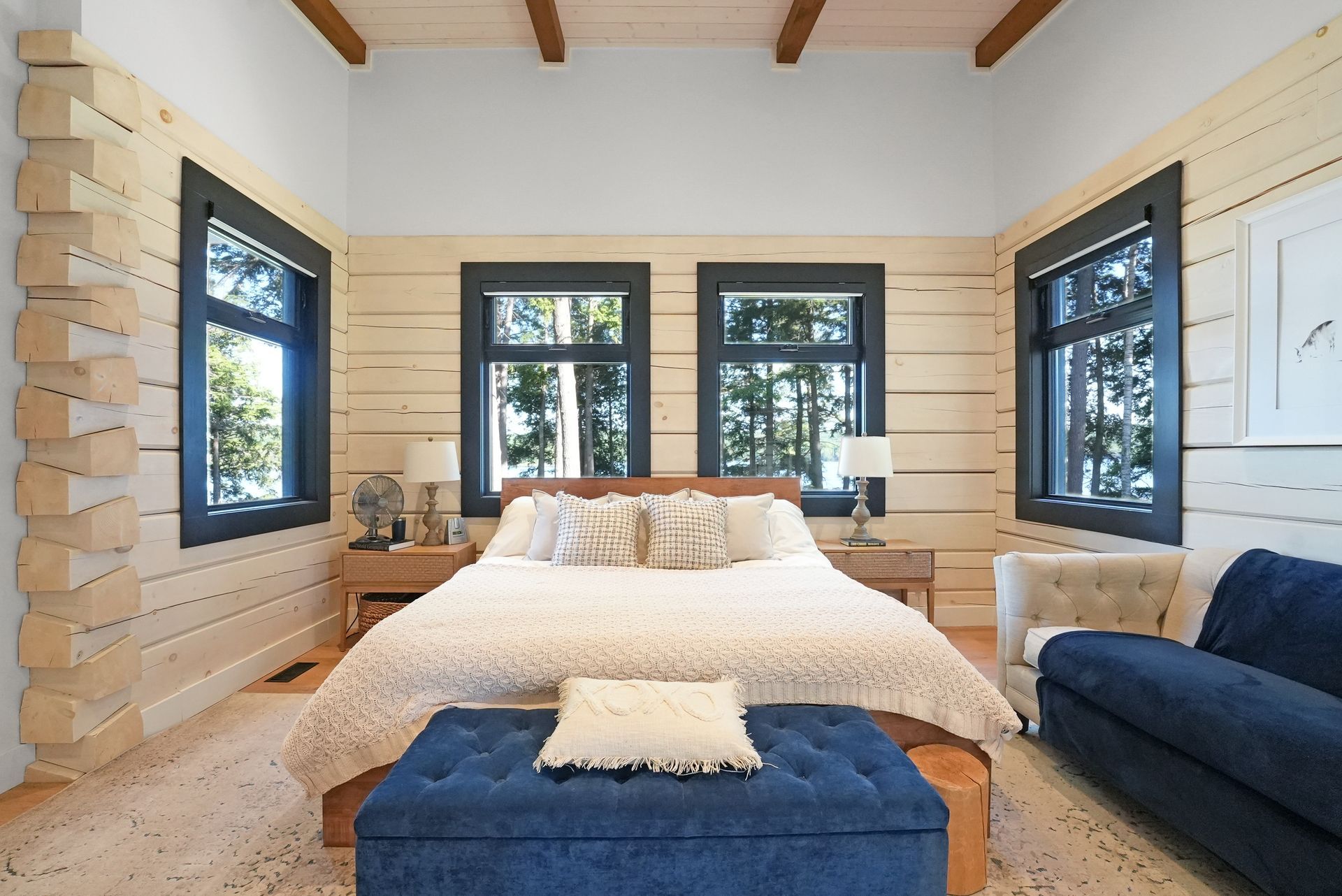 A bedroom with a king size bed and wooden walls