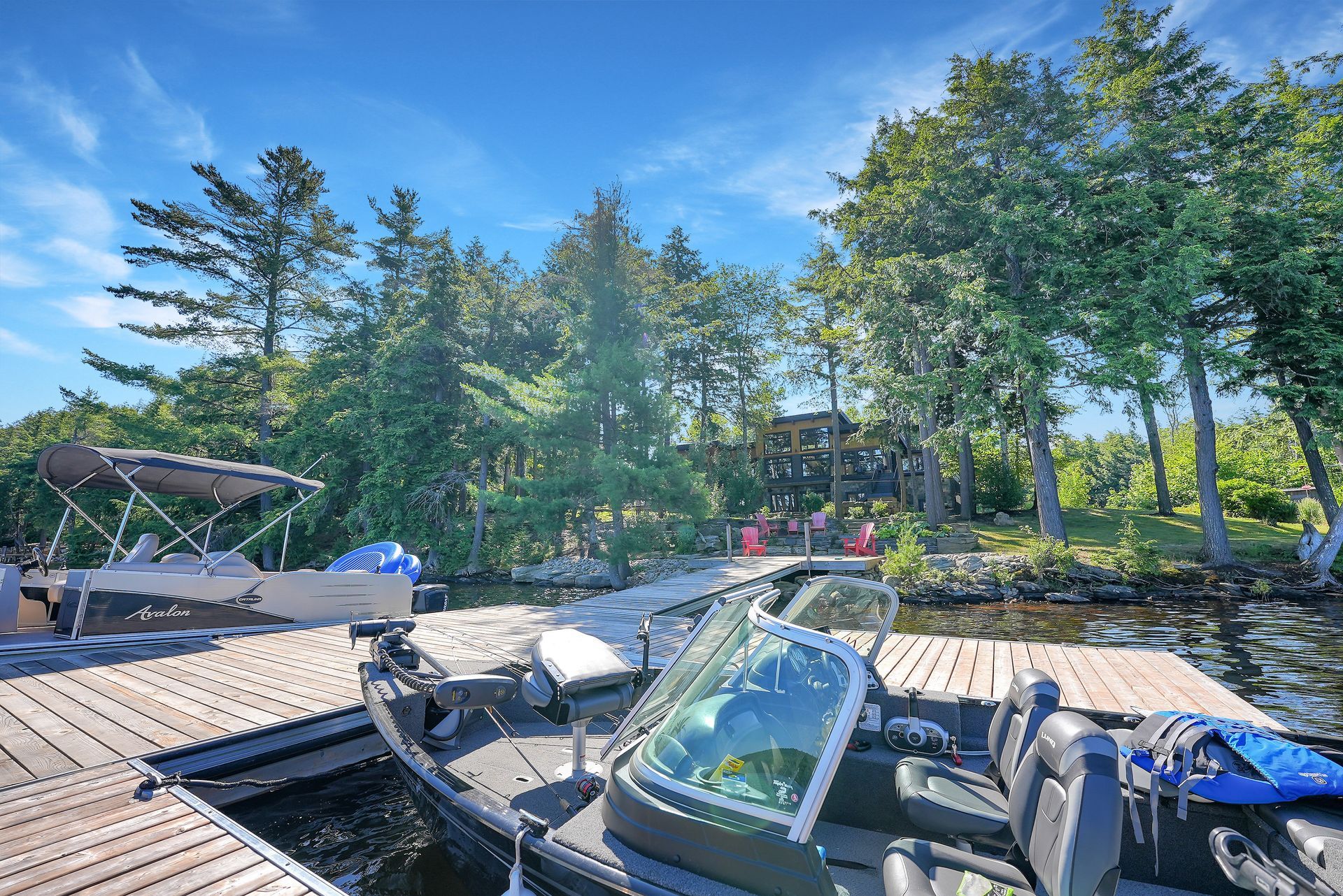 The sun is setting over a lake surrounded by trees.