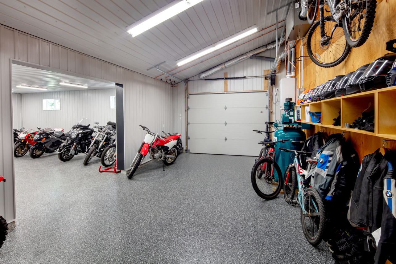 A garage filled with motorcycles and bicycles.