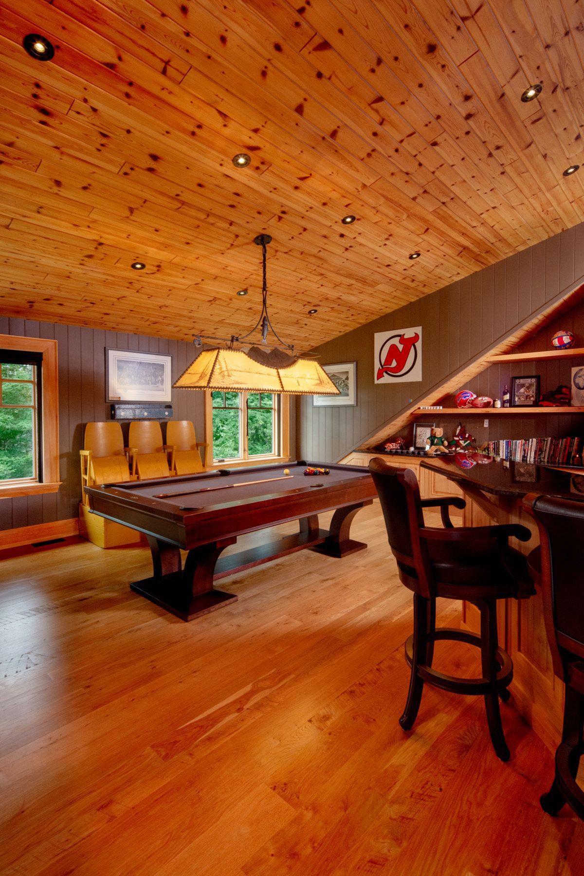 A game room with a pool table and a bar