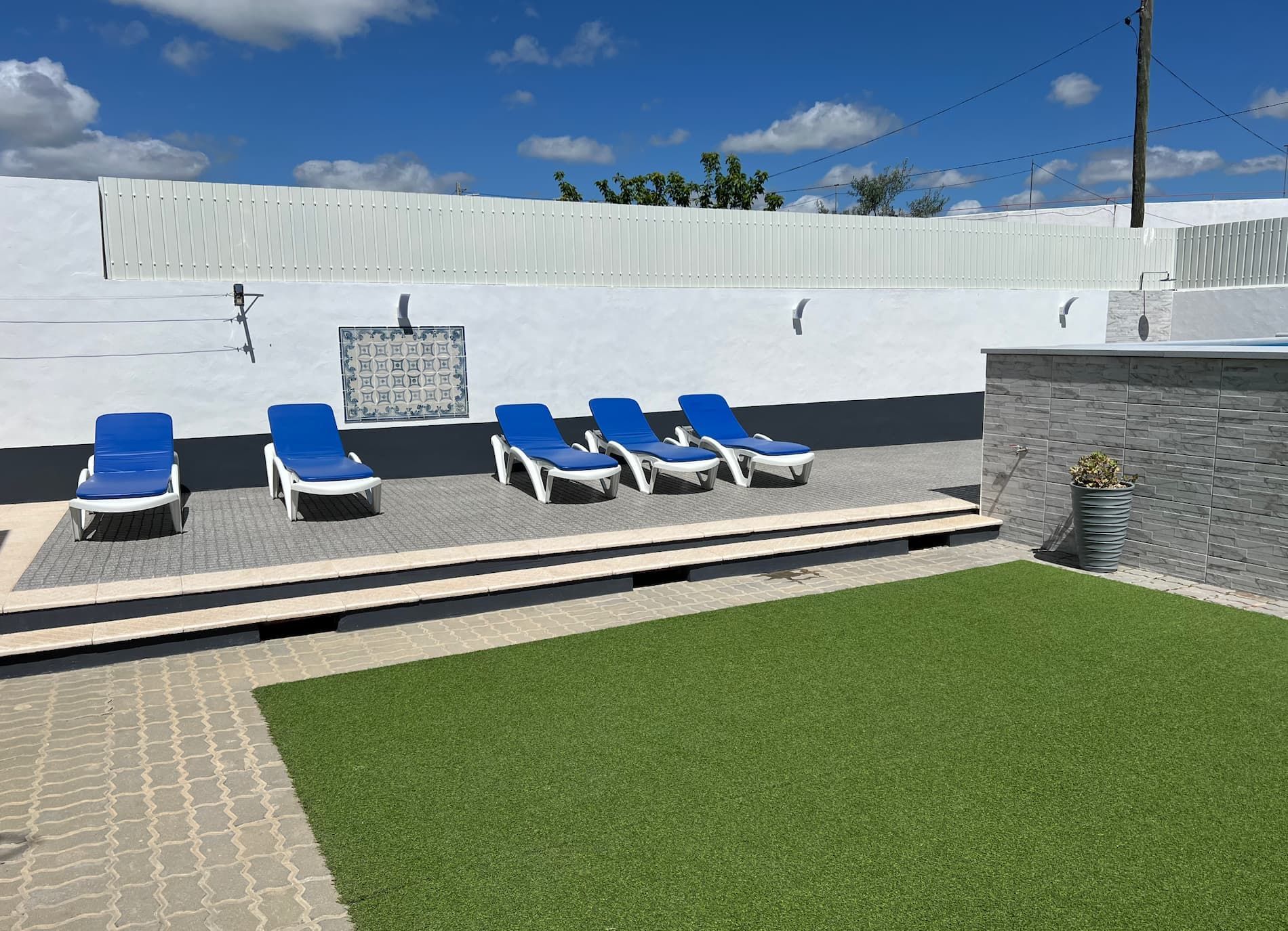 Um guarda-chuva verde está no topo de um gramado verdejante.