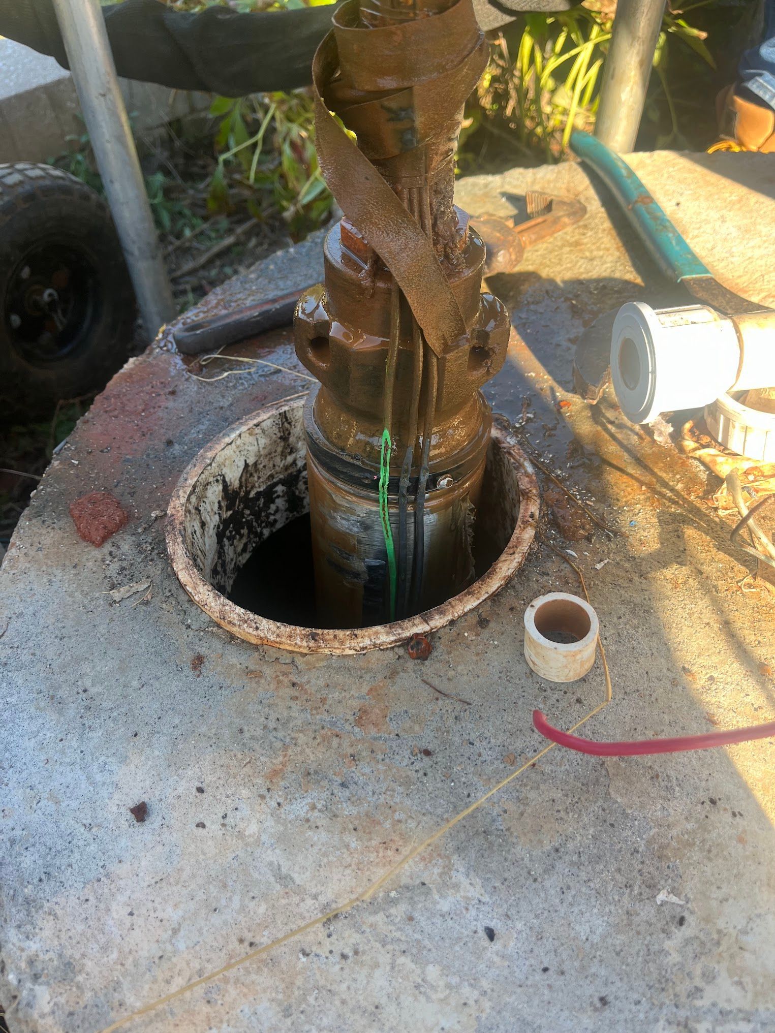 A water pump is being drilled into a concrete block.