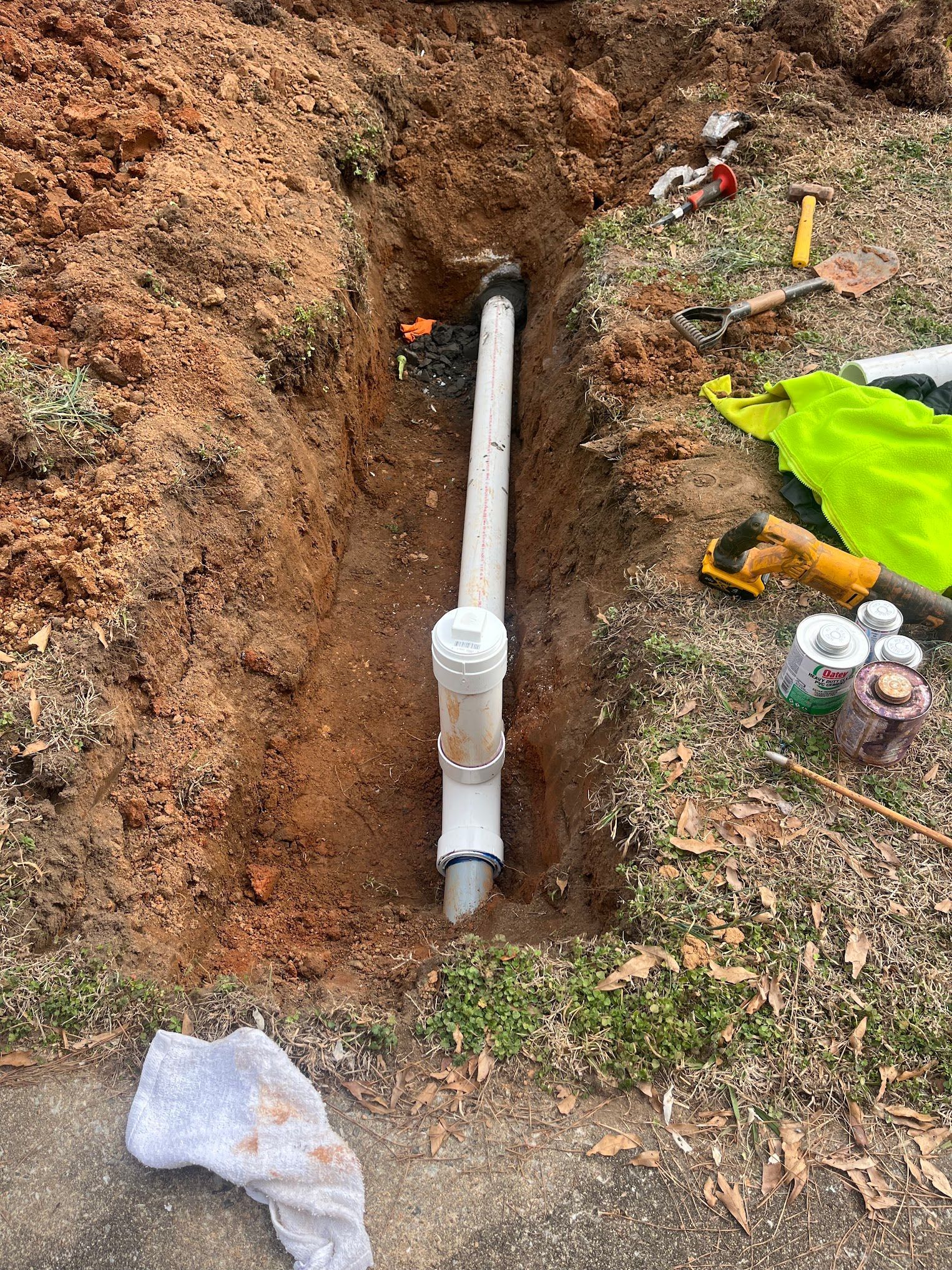 A pipe is being installed in a hole in the ground.