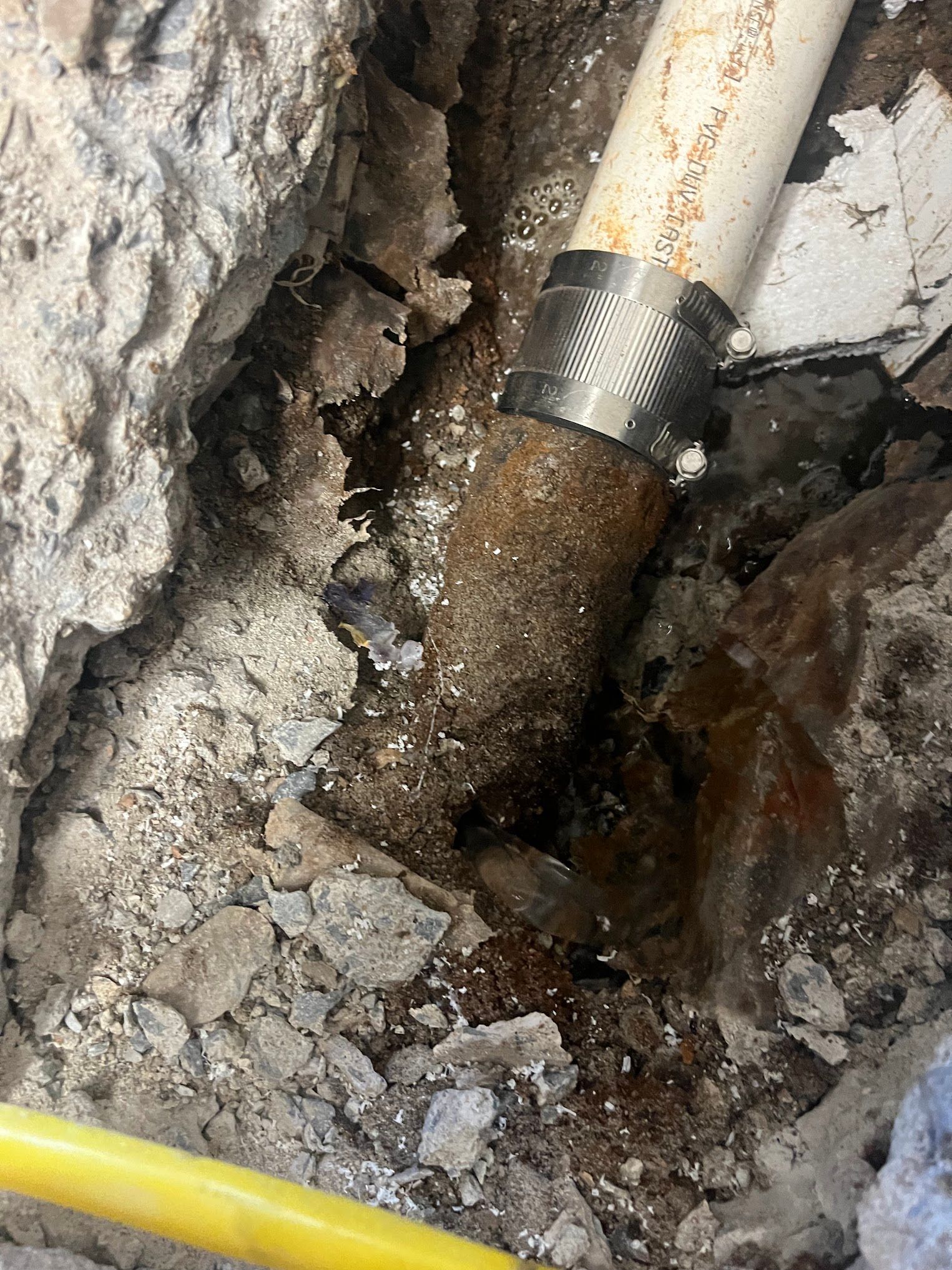 A pipe is coming out of a hole in the ground.