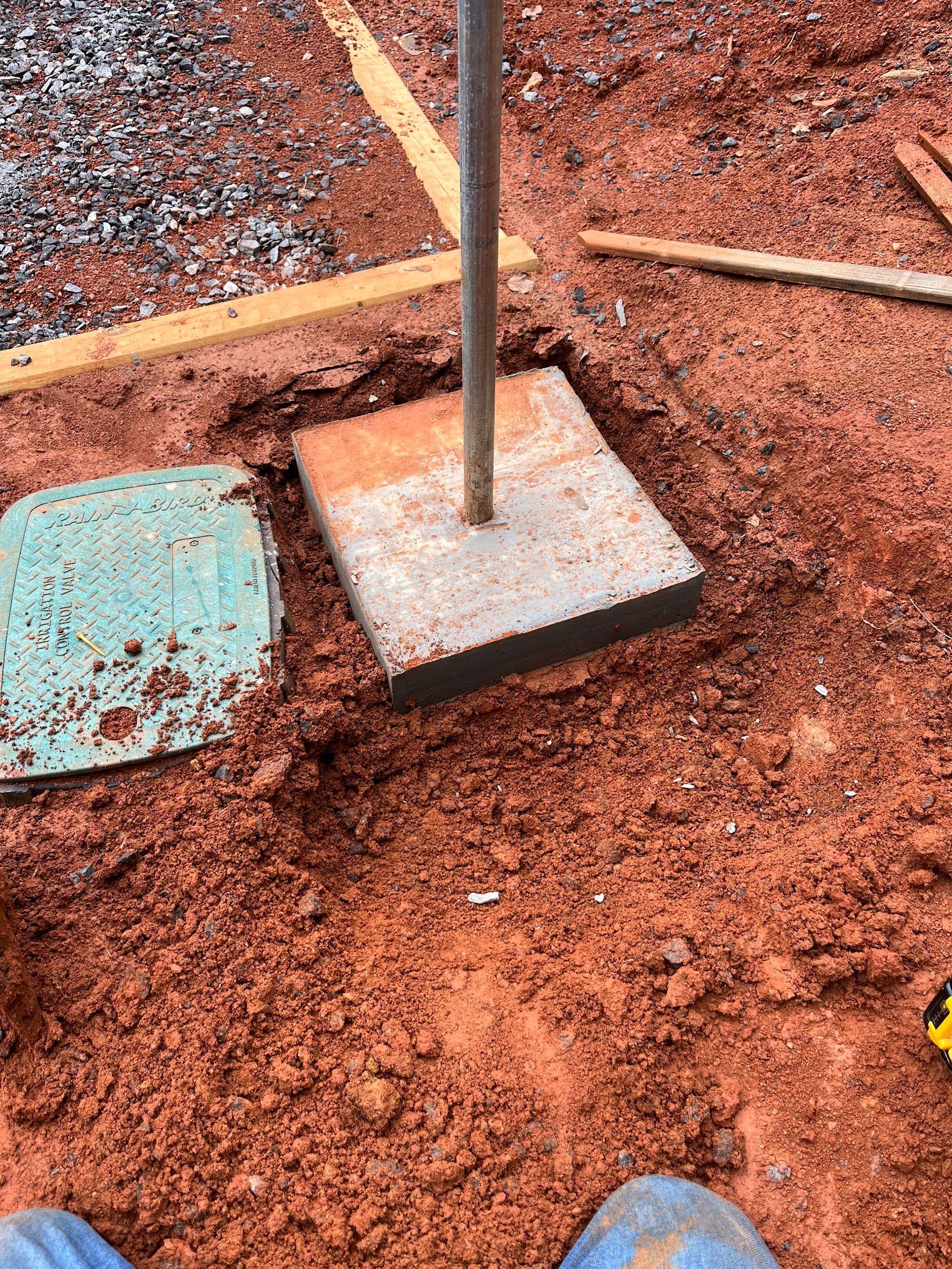 A person is digging a hole in the ground with a shovel.