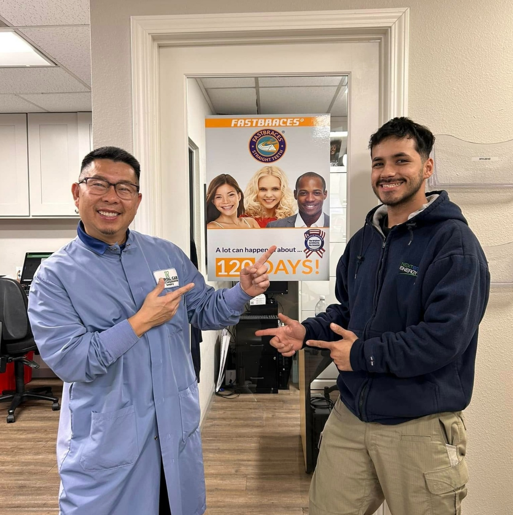 Two men are standing in front of a sign that says 120 days