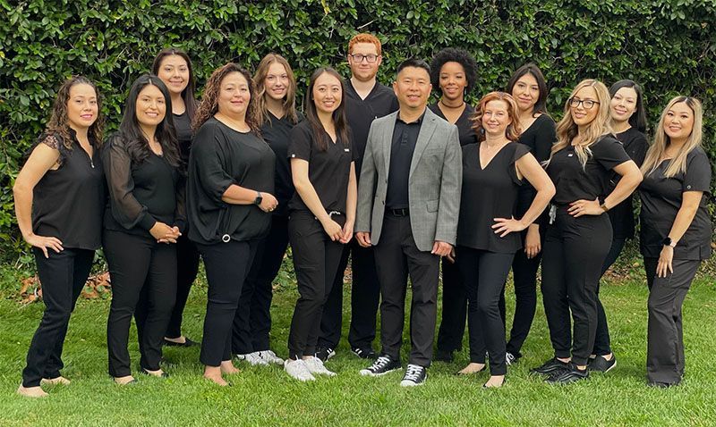 A group of people in black uniforms are posing for a picture.