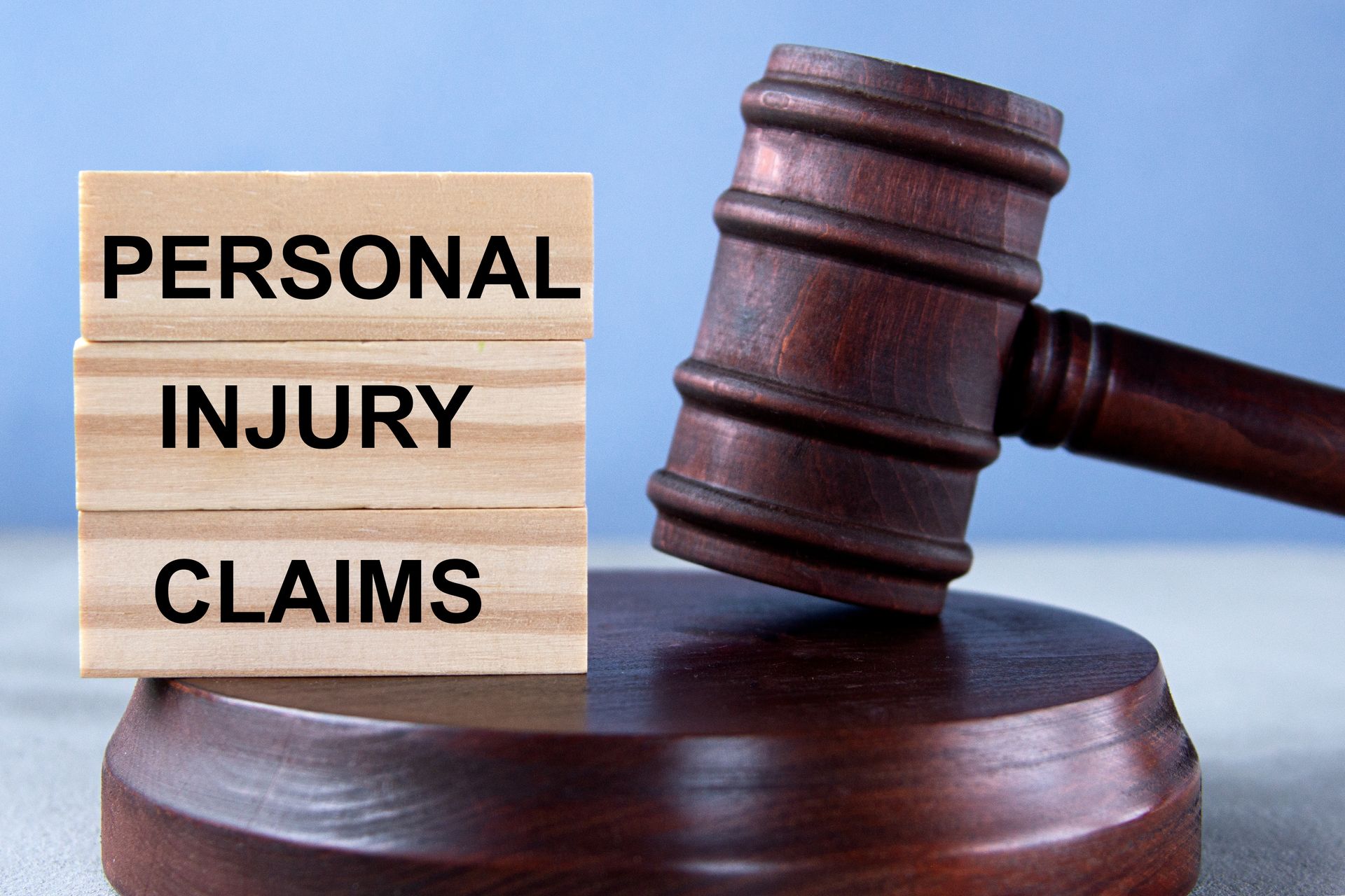 A wooden gavel beside stacked blocks displaying the words “Personal Injury Claims.” A wooden gavel beside stacked blocks displaying the words “Personal Injury Claims.”