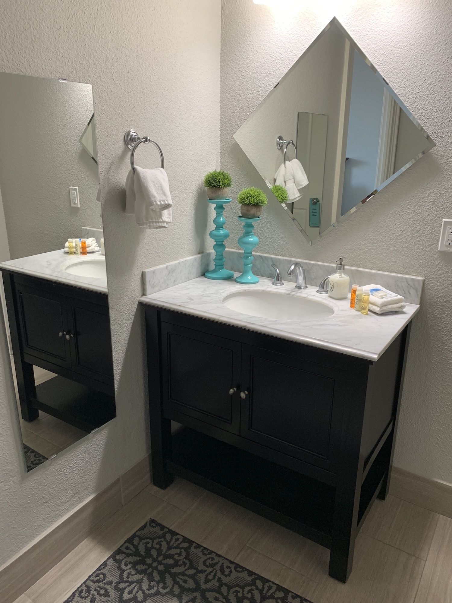A bathroom with a sink , mirror and vanity.
