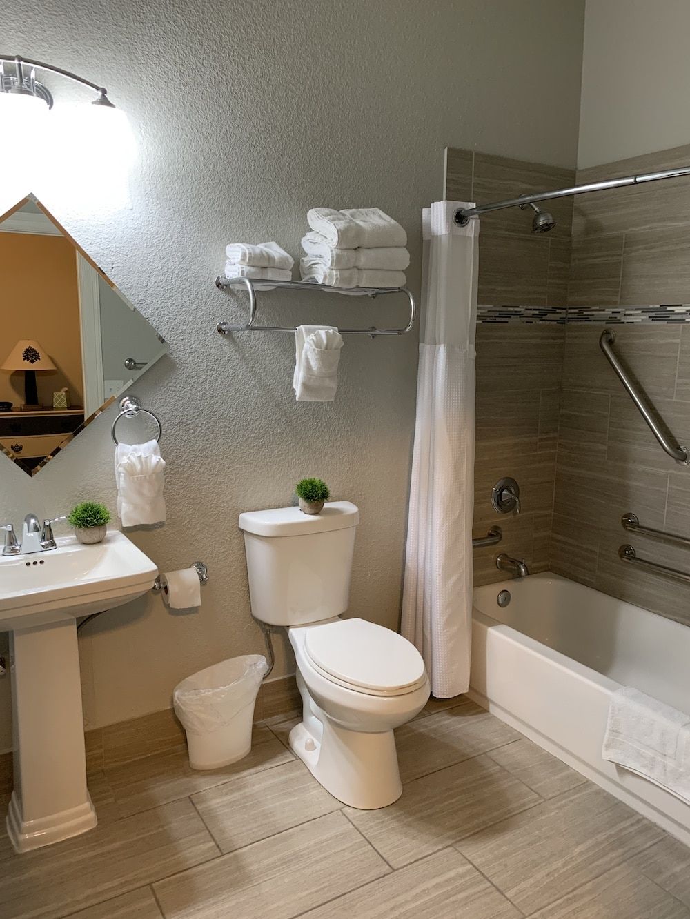 A bathroom with a toilet , sink , and bathtub.