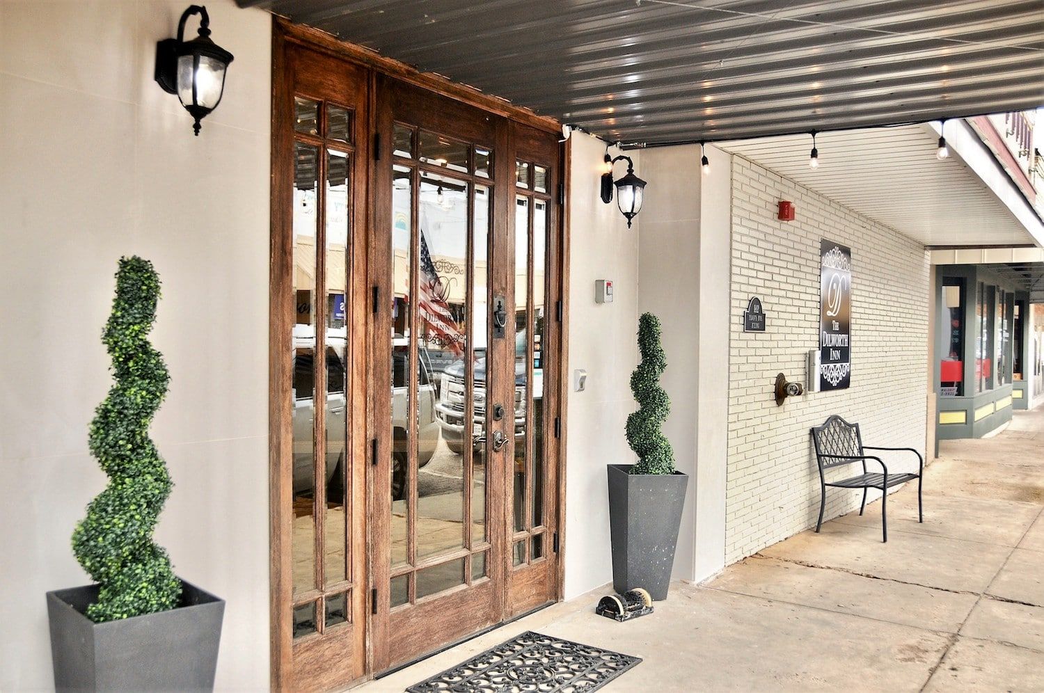 A building with a large glass door and a bench in front of it.
