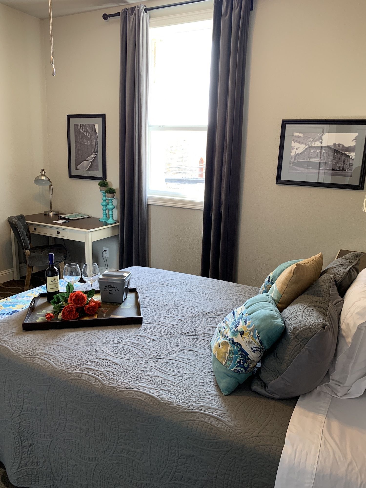 A bed with a tray of food on it in a bedroom.
