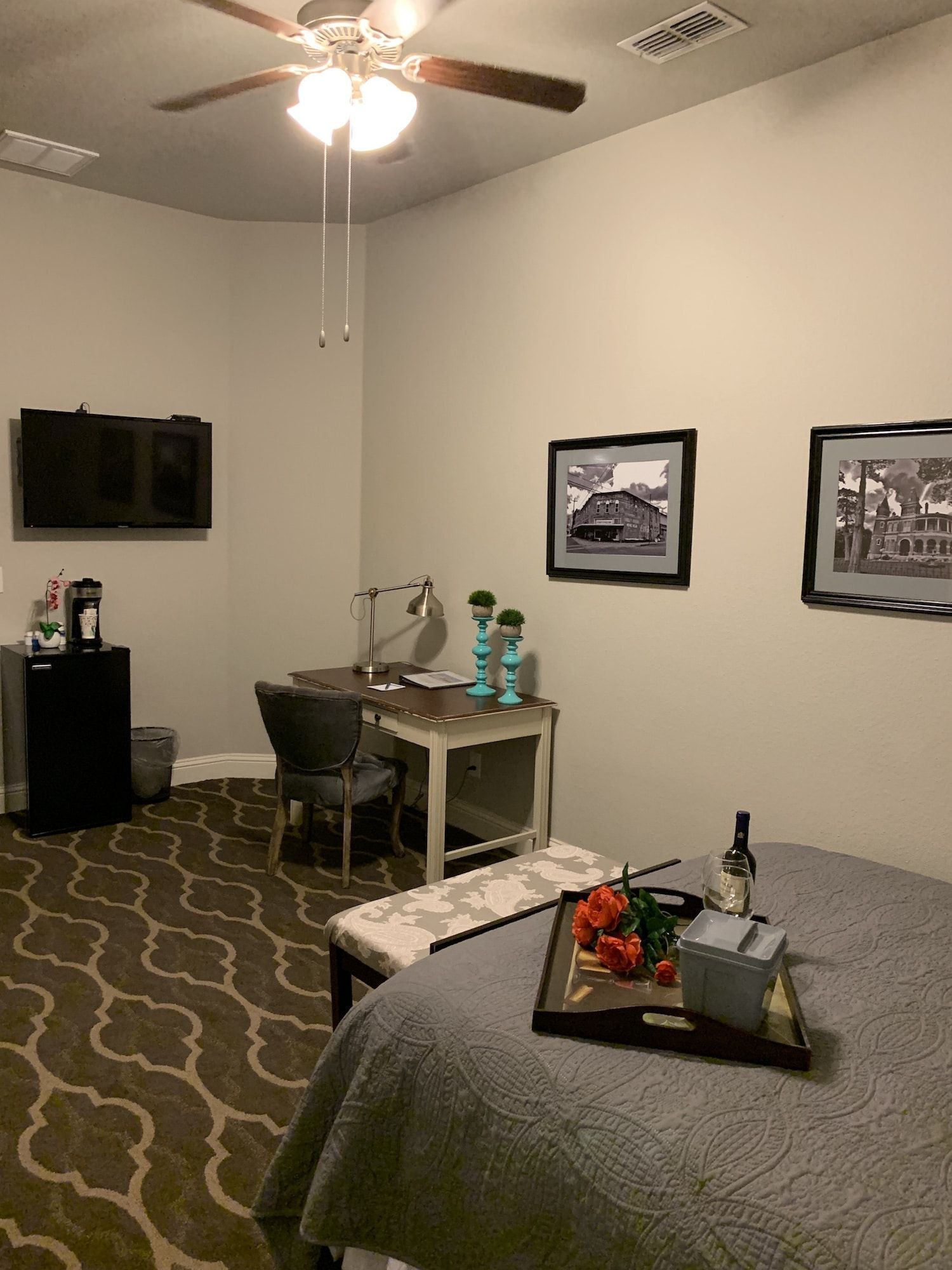 A bedroom with a bed , desk , chair and television.