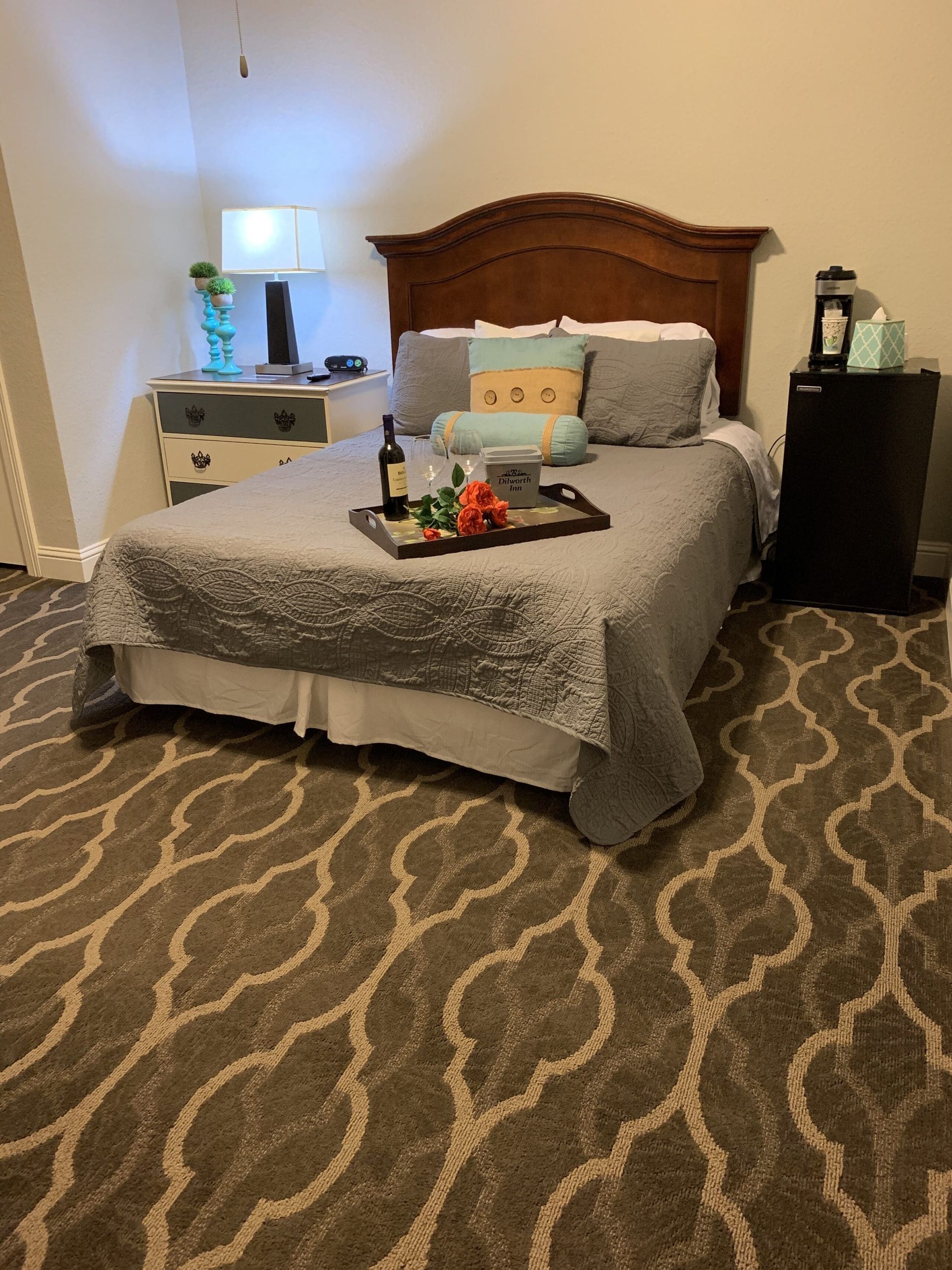 A bedroom with a bed and a tray of food on it.