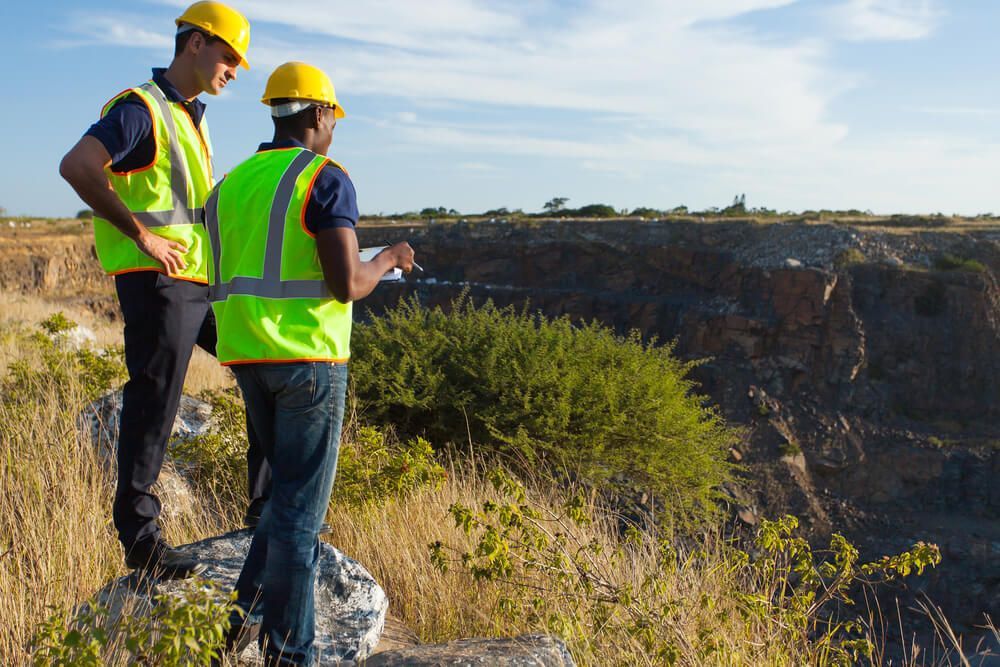 Two Male Surveyors Working at Mining Site — Financial Advice in Queensland