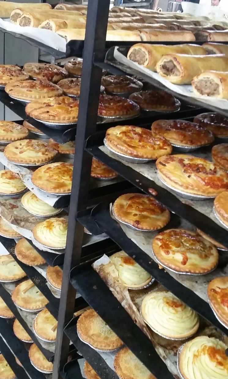 Shelves of baked pies and sausage rolls in a bakery— Bread Basket in Kurri Kurri, NSW