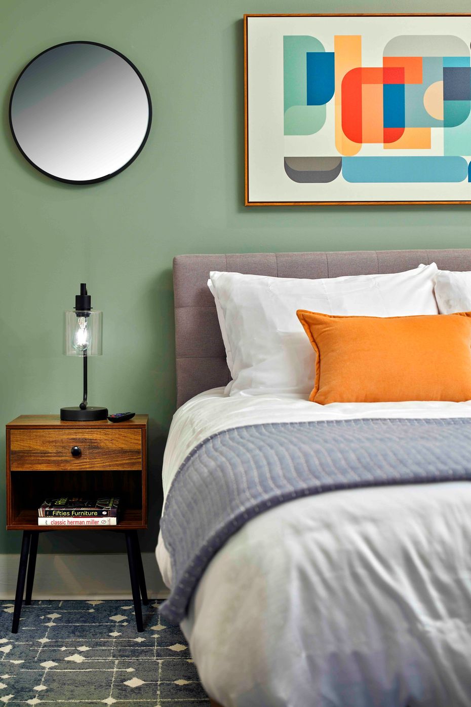 a bedroom with two beds and two paintings on the wall .