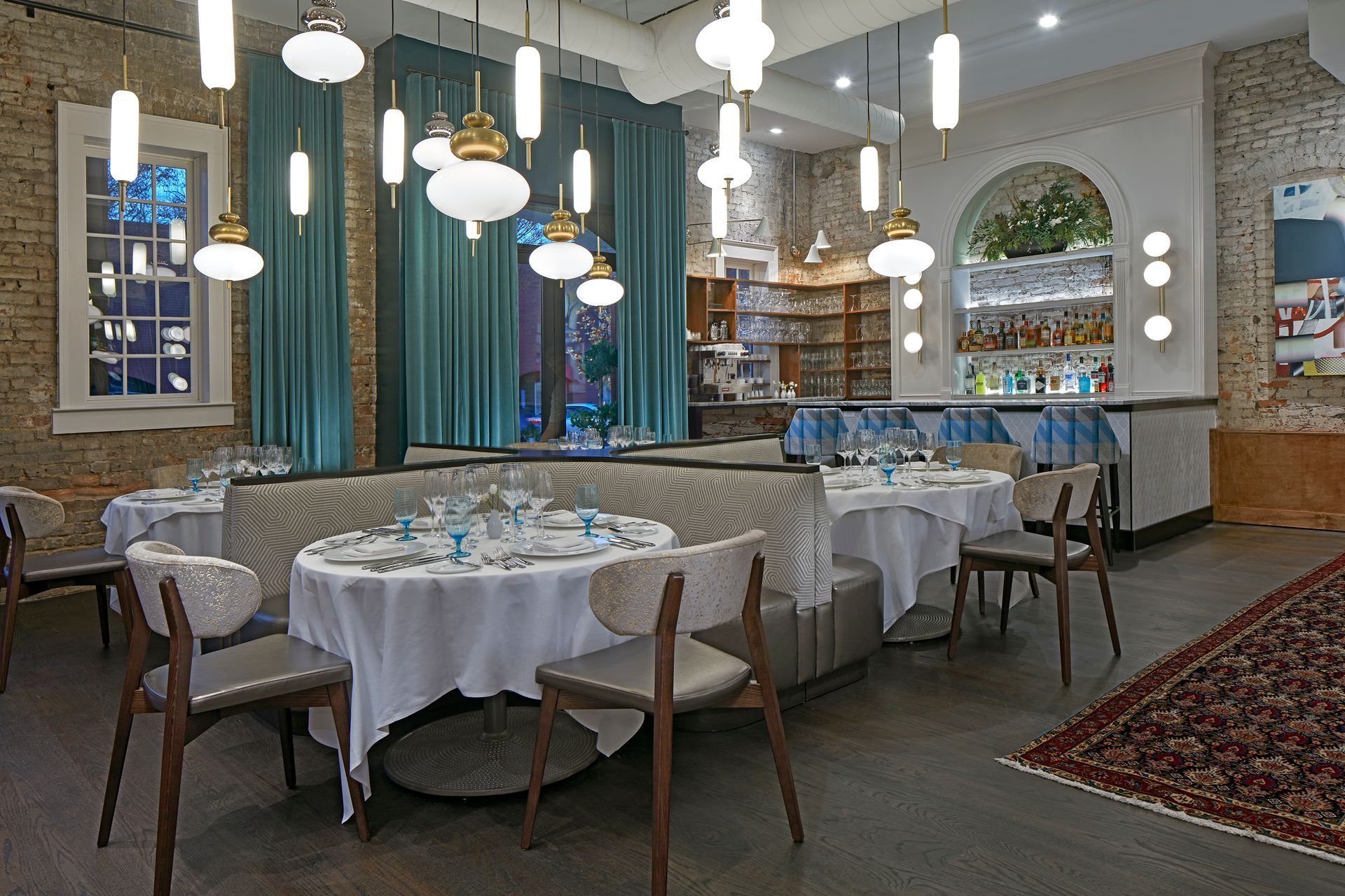 a restaurant with a bar and a lot of glasses on the counter .