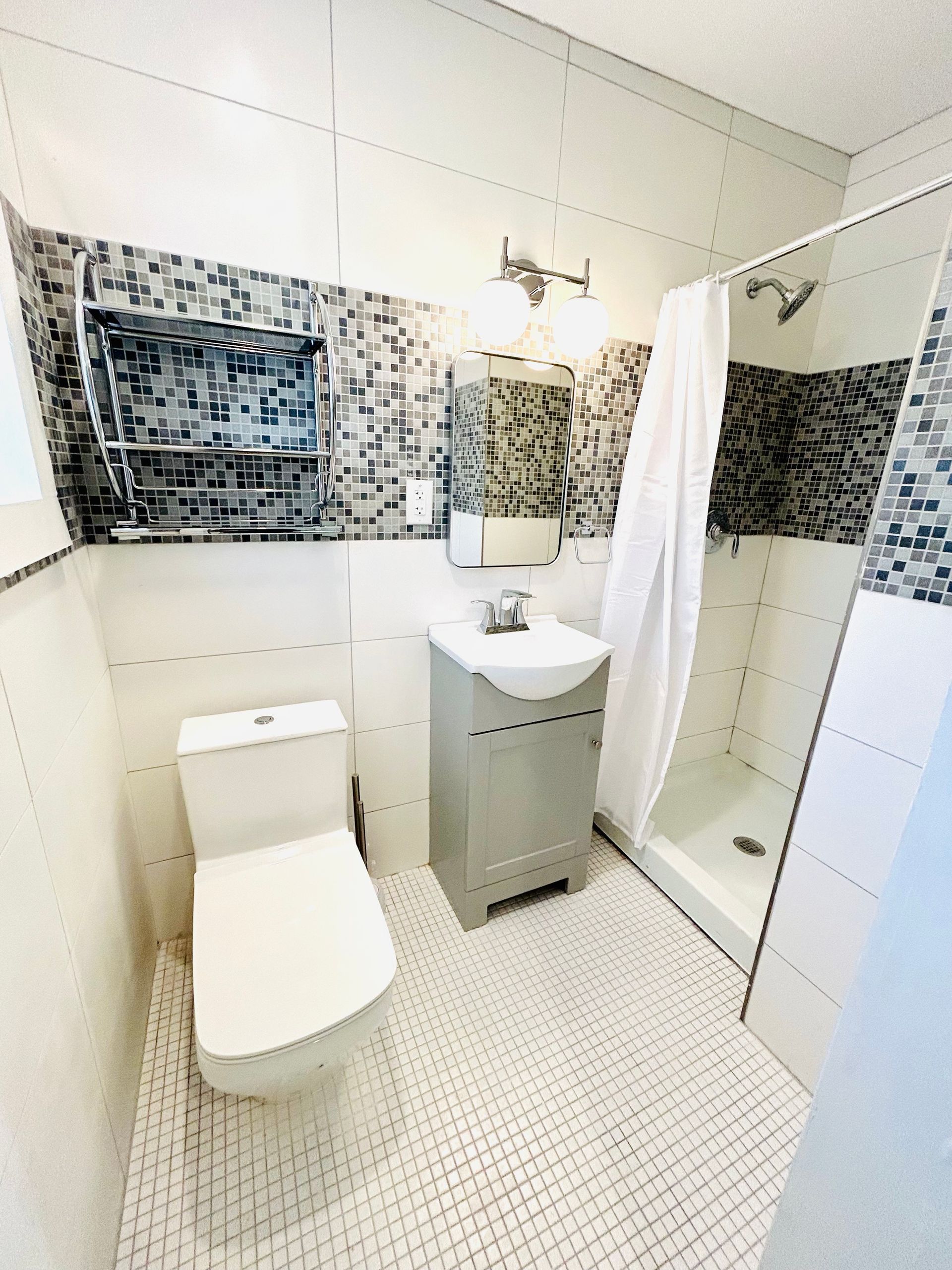 a bathroom with a toilet a sink and a shower