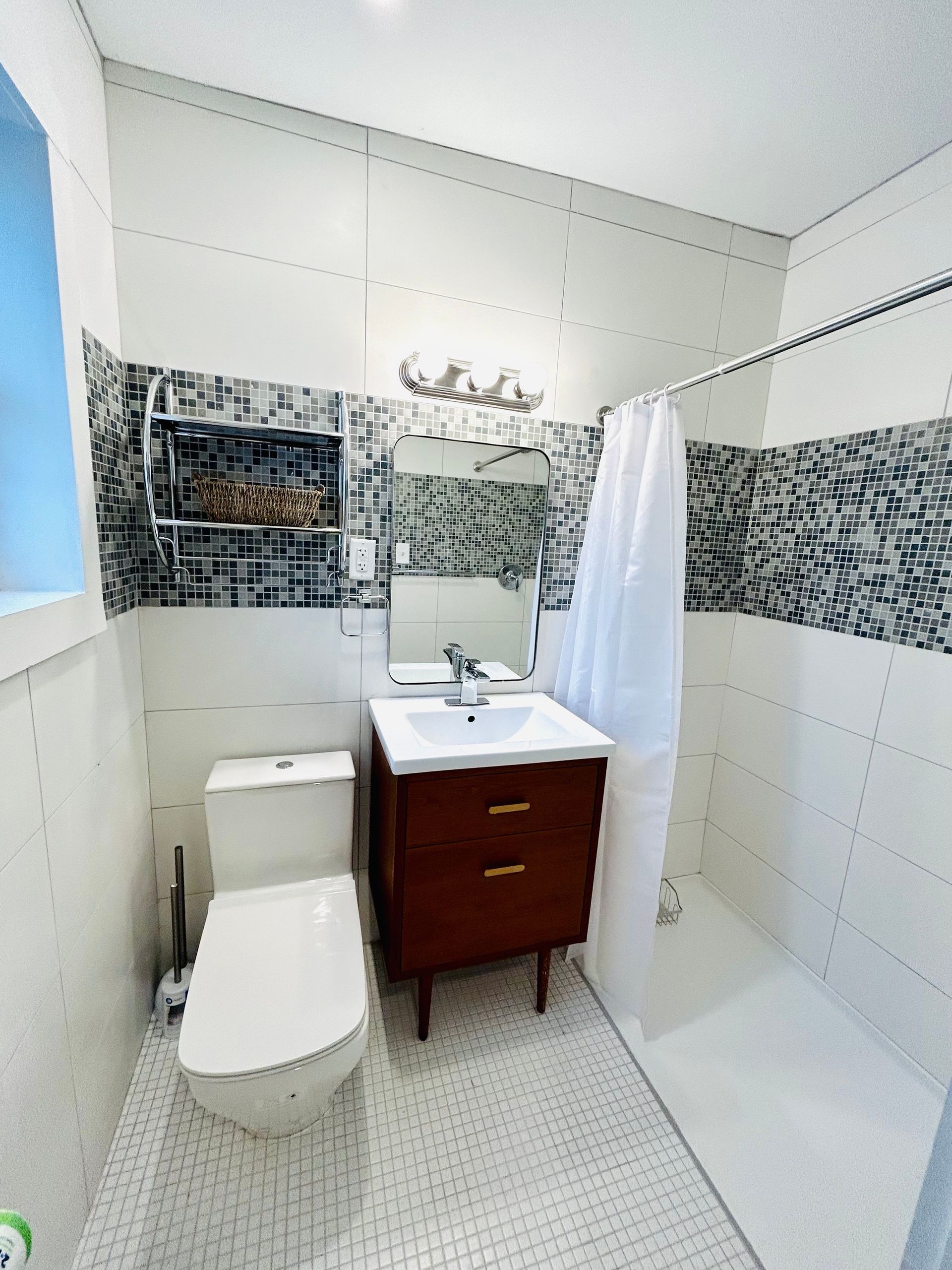 a bathroom with a toilet , sink and shower