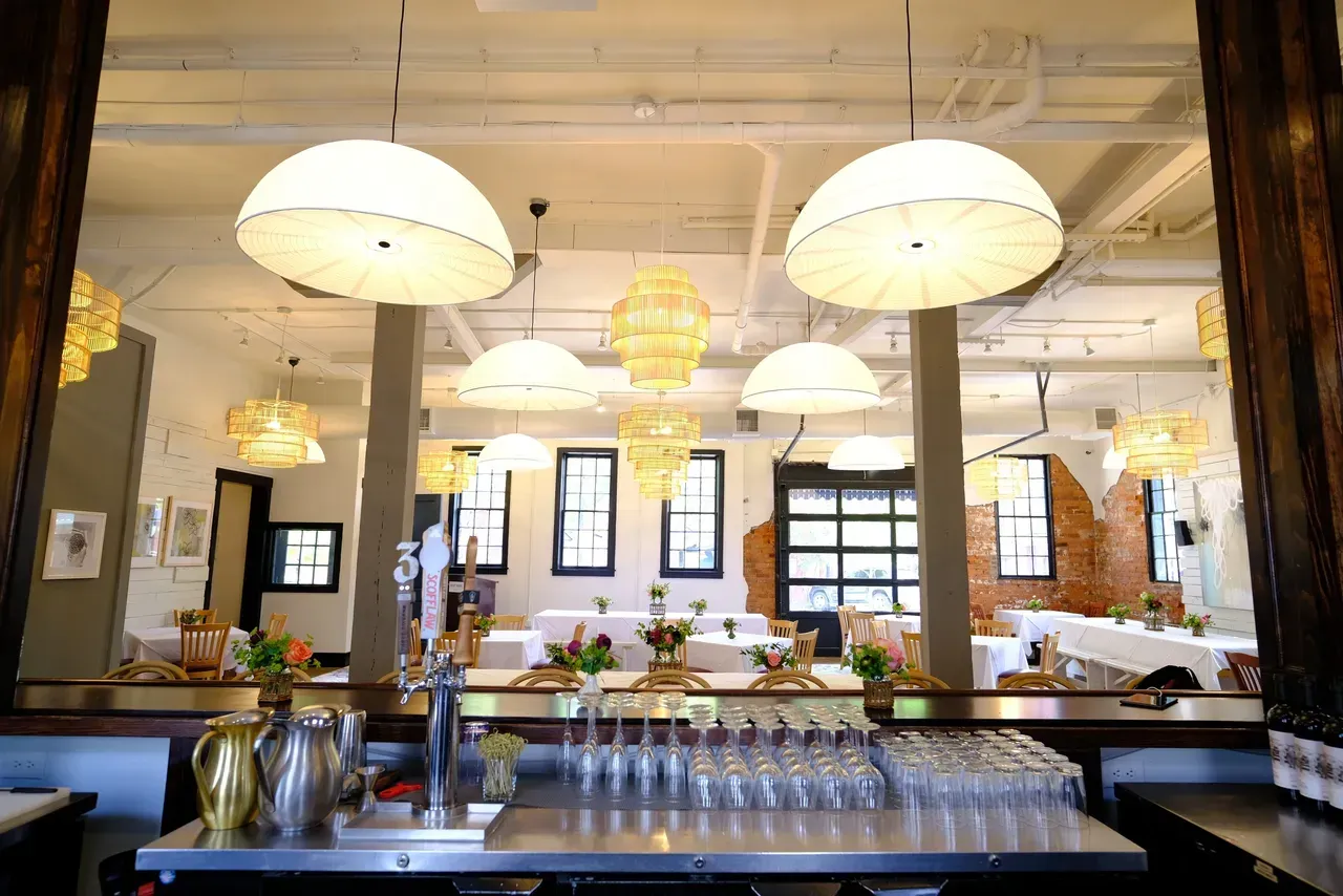 a restaurant with a bar and a lot of glasses on the counter .