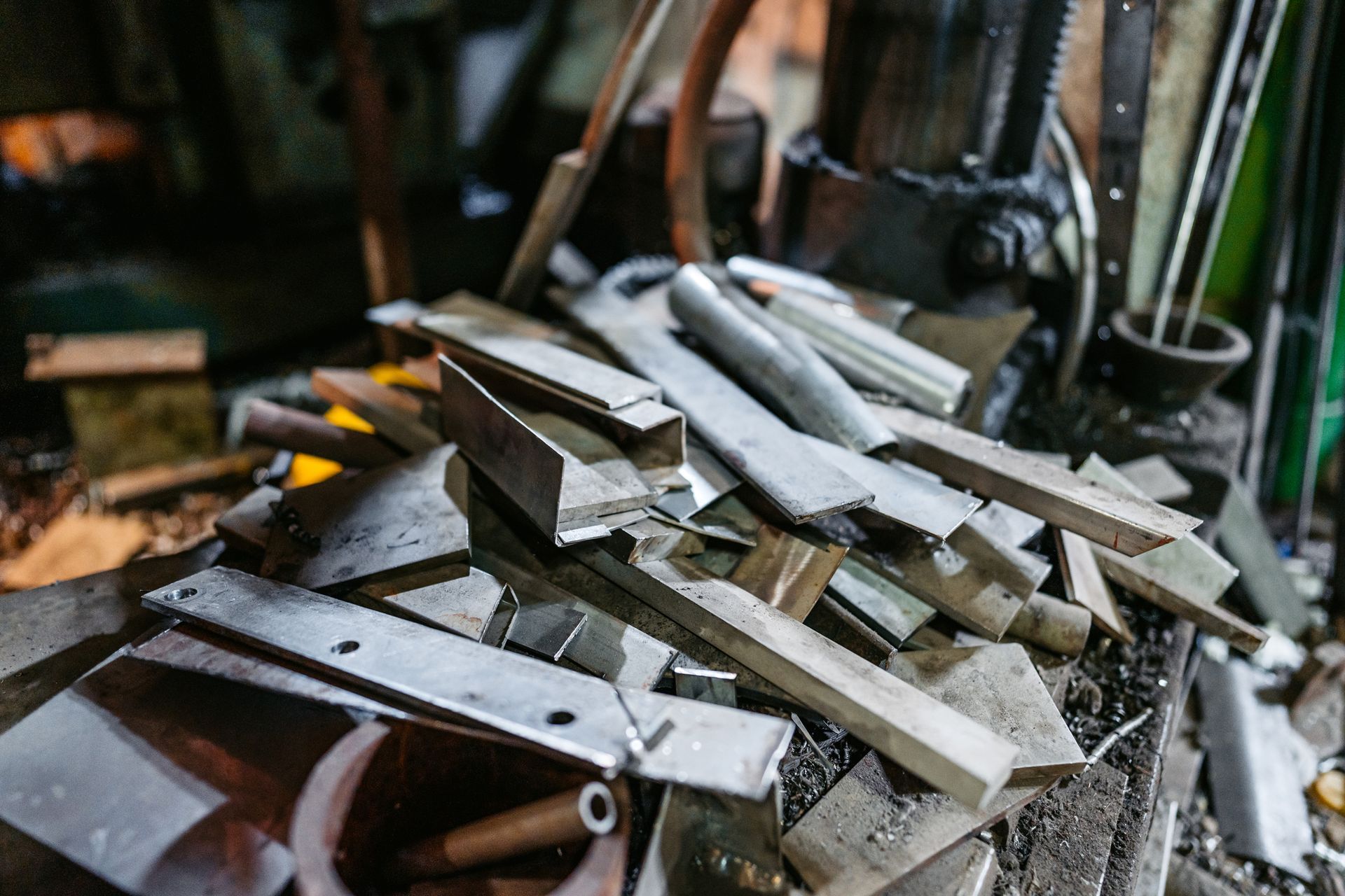 Metalworking tools and materials on a workshop bench.
