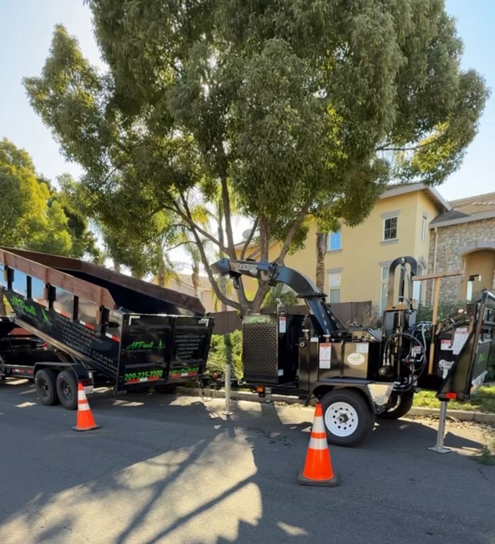 A tree chipper is parked on the side of the road