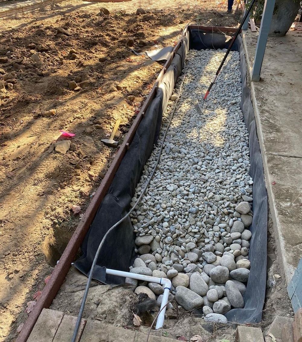 A person is digging a hole in the ground with a shovel.