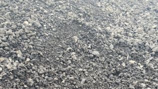 A pile of gravel is sitting on the ground.