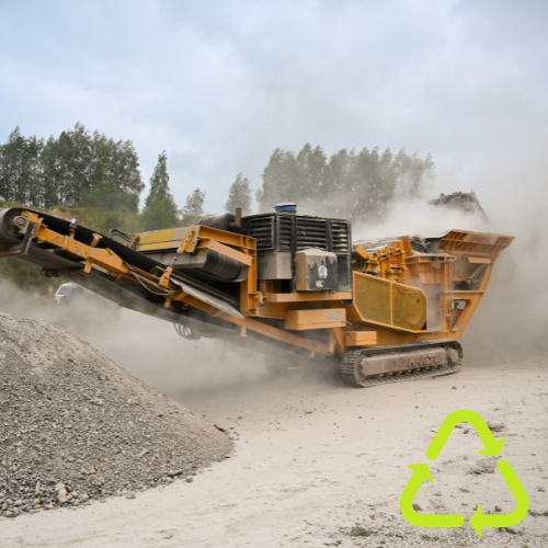Two yellow trucks are driving down a dirt road.