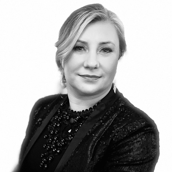 A black and white photo of a woman in a black jacket.