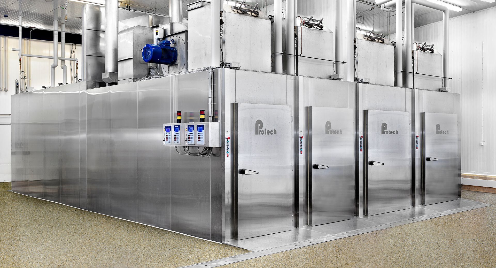 A large stainless steel machine is sitting in a room.