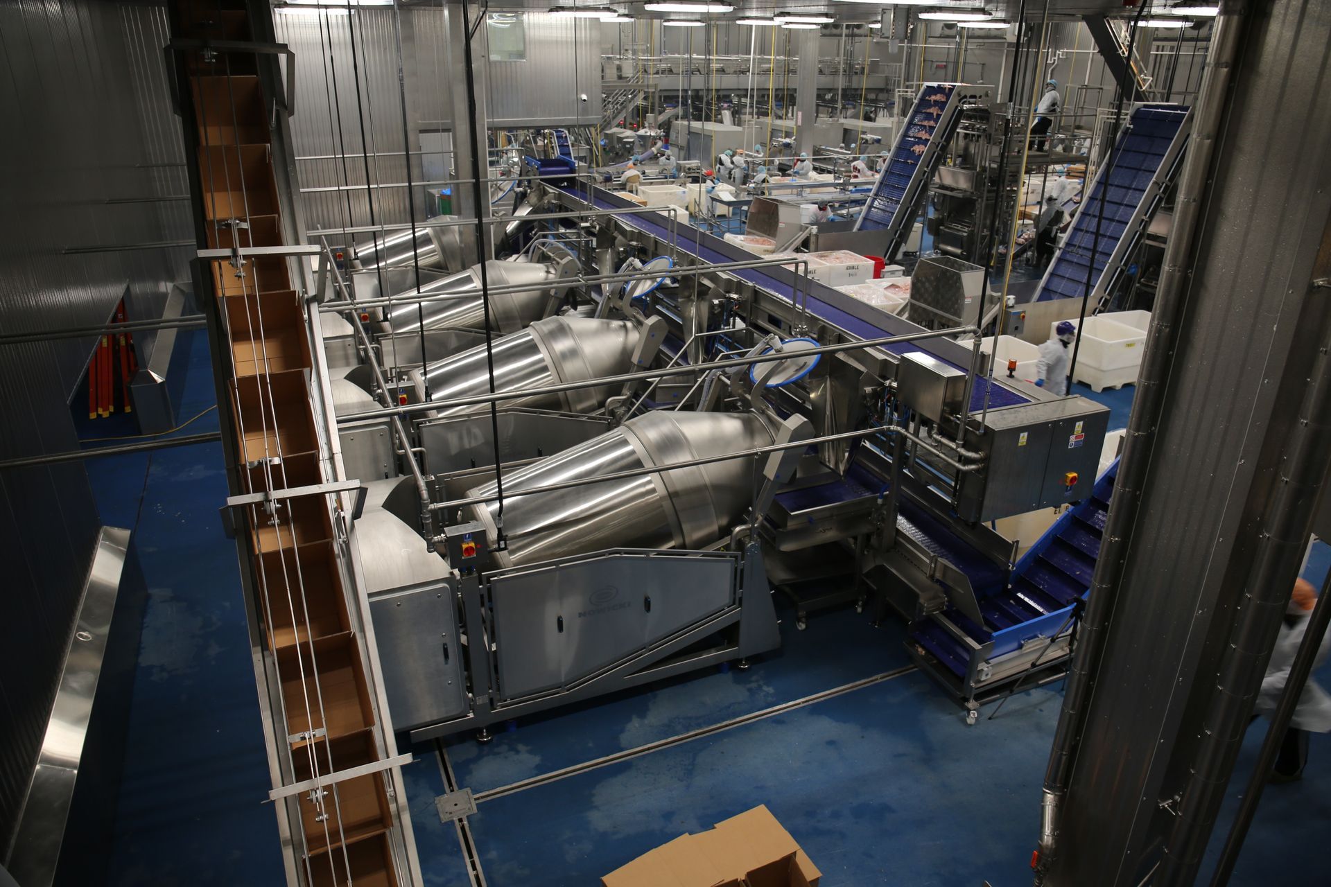 A factory with a lot of machinery and boxes on the floor