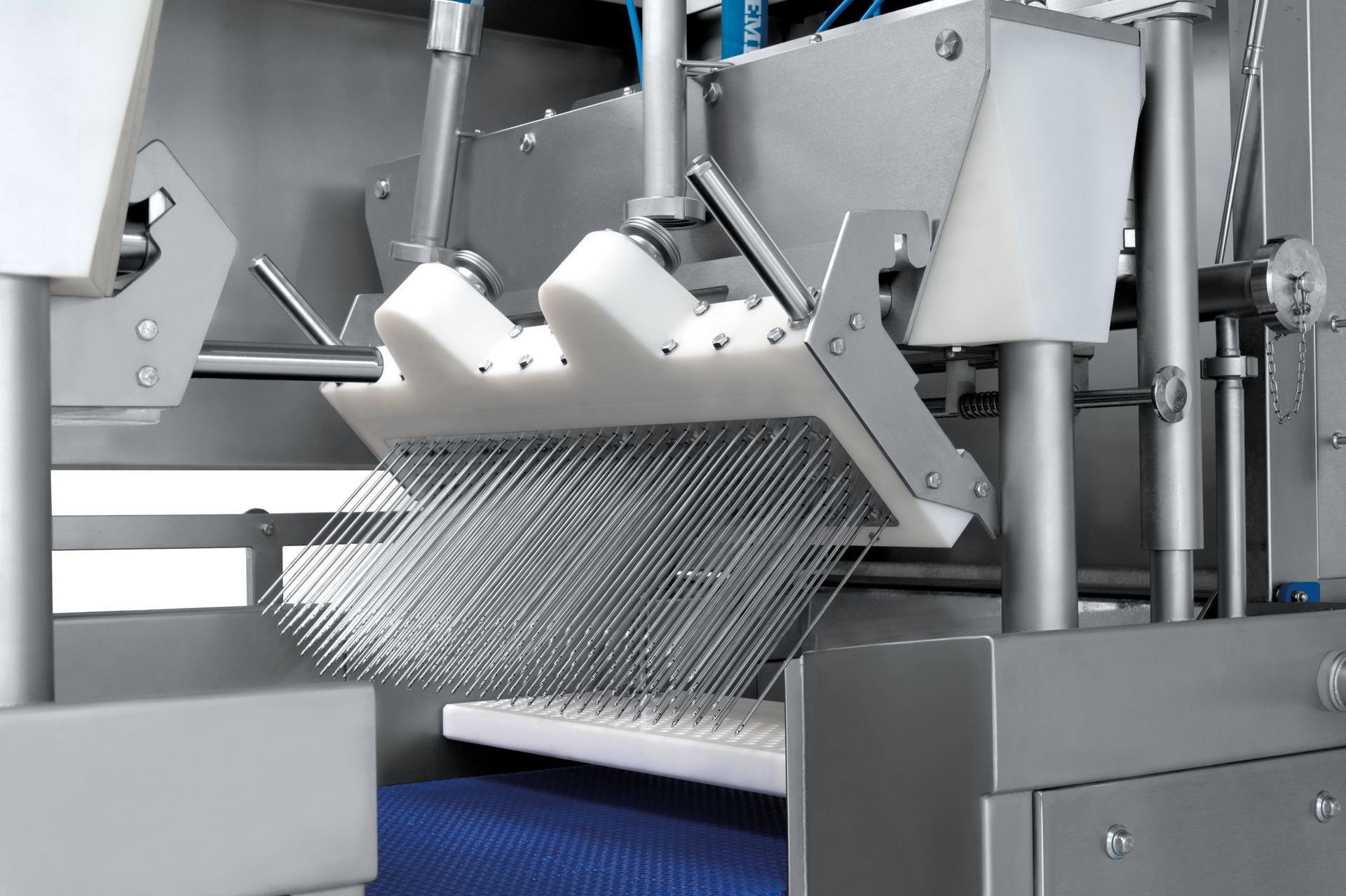 A close up of a machine with a blue belt going through it.