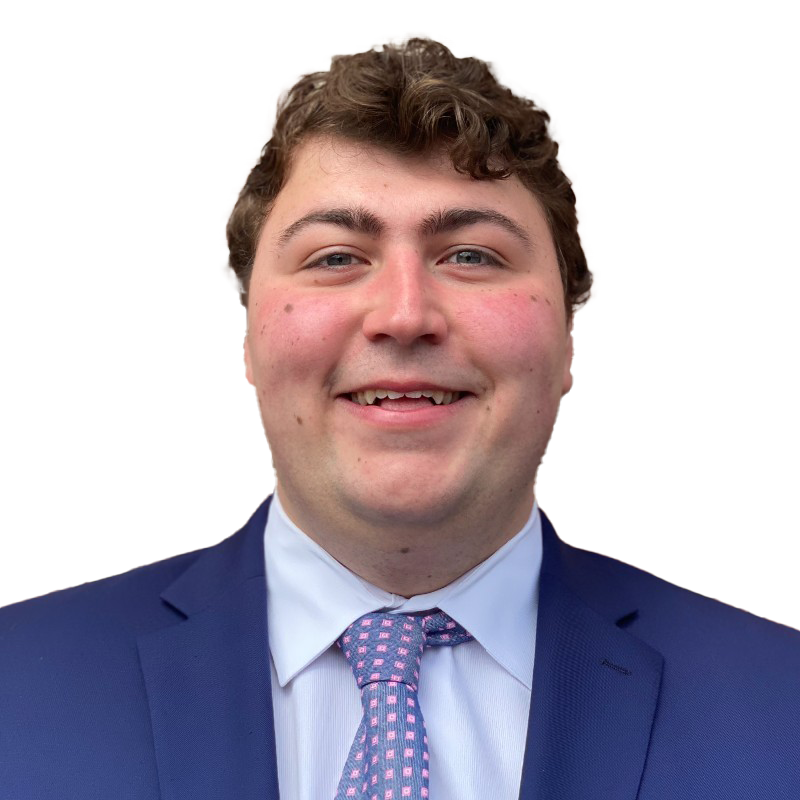 A man in a suit and tie is smiling for the camera