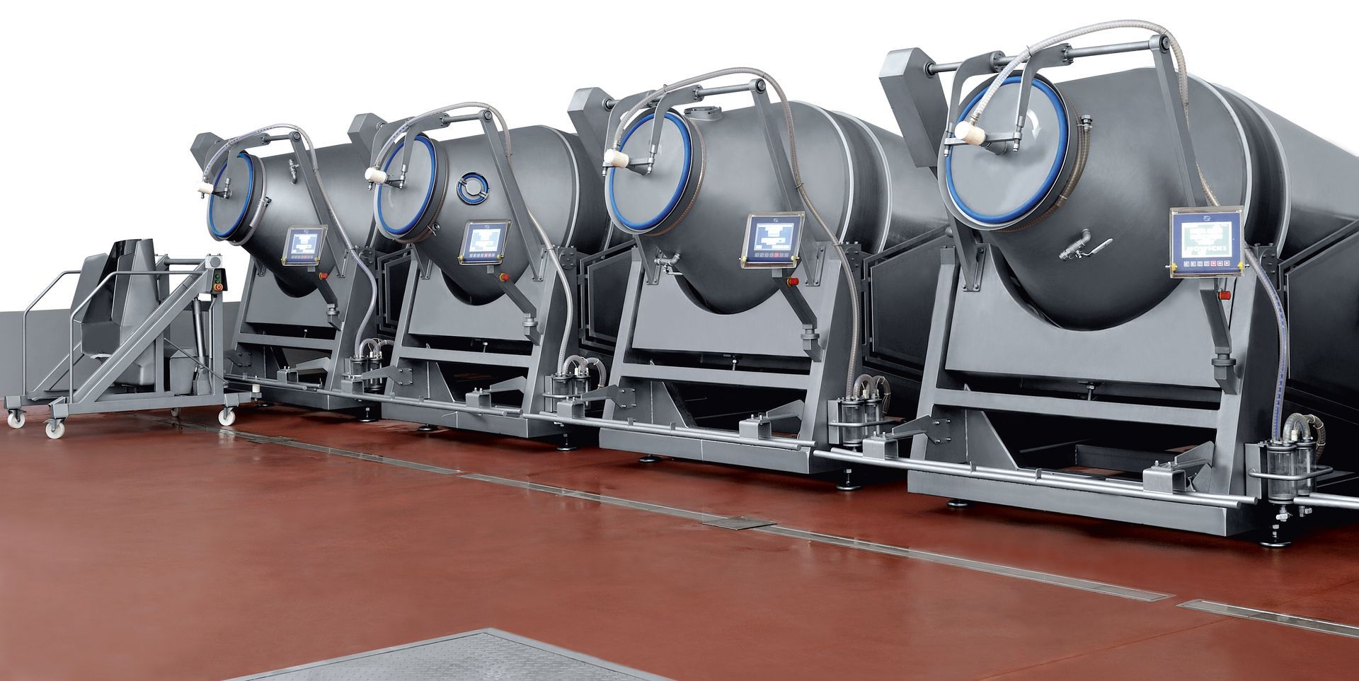 A row of mixers are lined up in a row on a red floor.