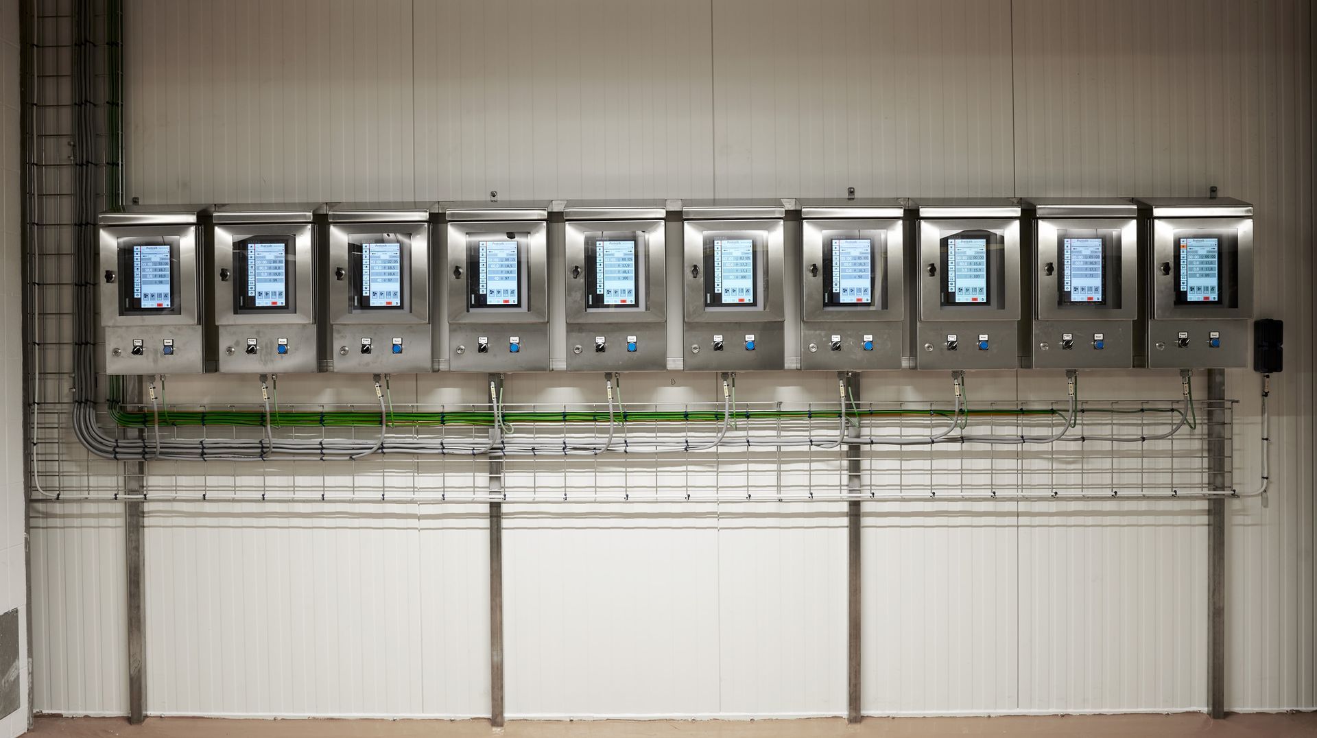 A row of stainless steel boxes with screens on them