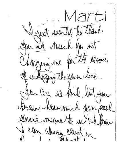 A handwritten letter is written in black ink on a white background.