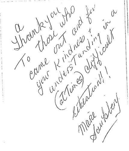 A thank you note is written in cursive on a piece of paper.