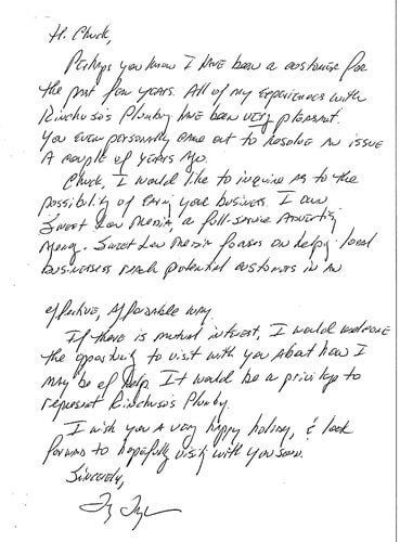 A letter is written in cursive on a piece of paper.