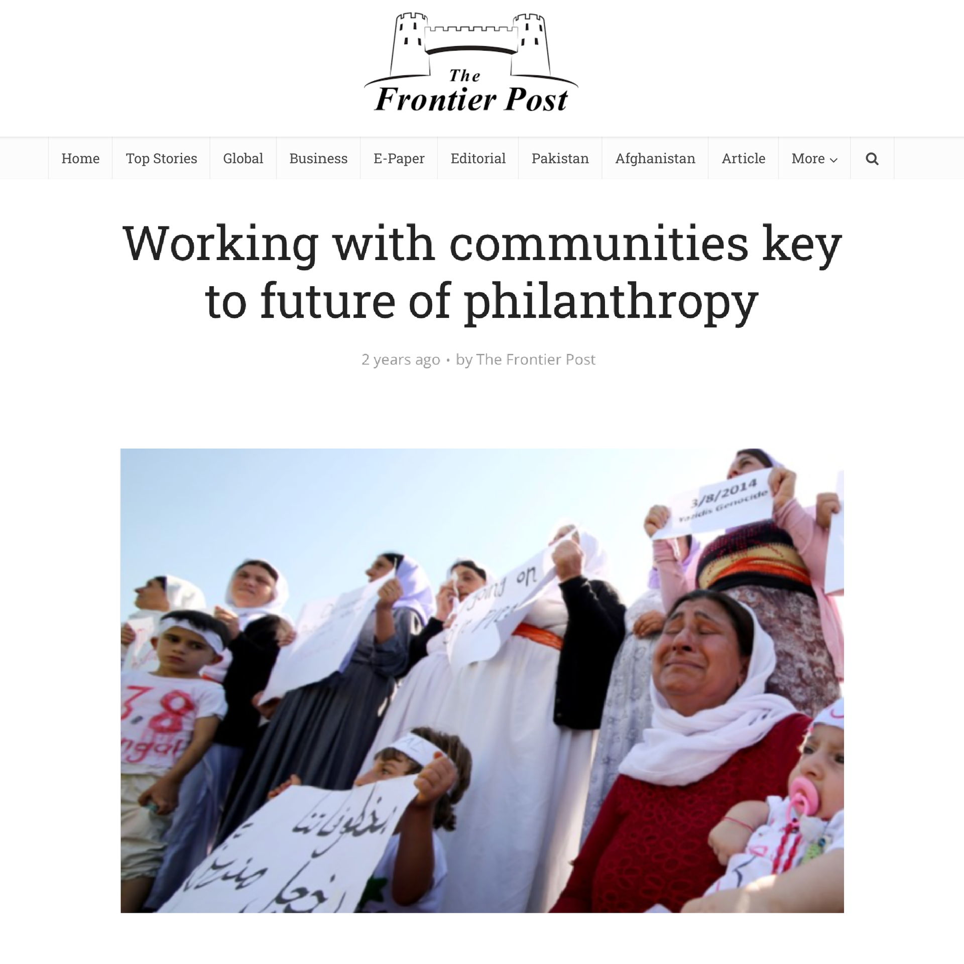 Frontier post media feature: Working with communities key to future of philanthropy. Image of Yazidi people holding signs