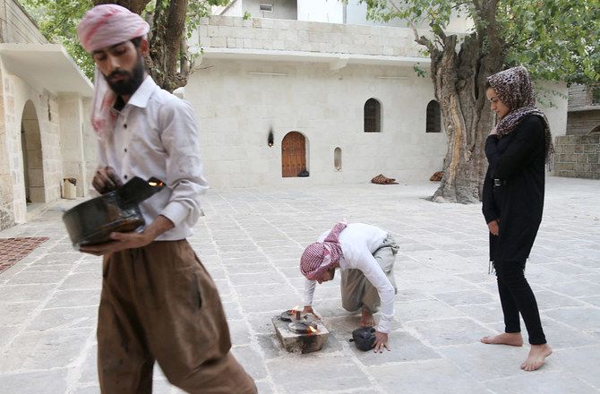 Arab News article titled “New documentary reveals threats to the Yazidi community in Iraq,” a man outdoors & a woman.