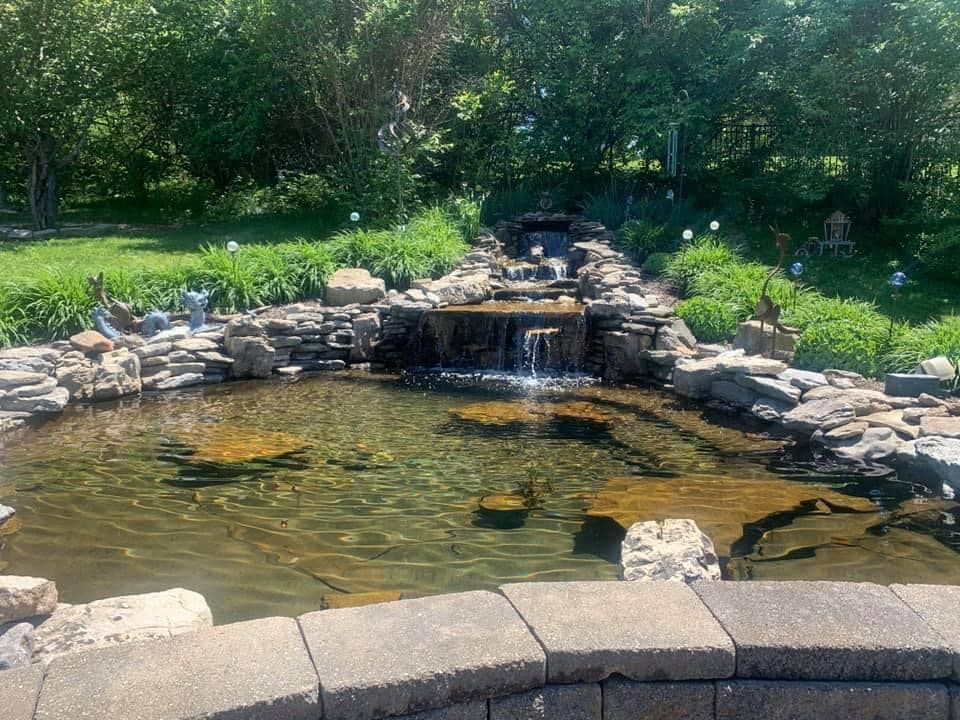A pond with a waterfall in the middle of it