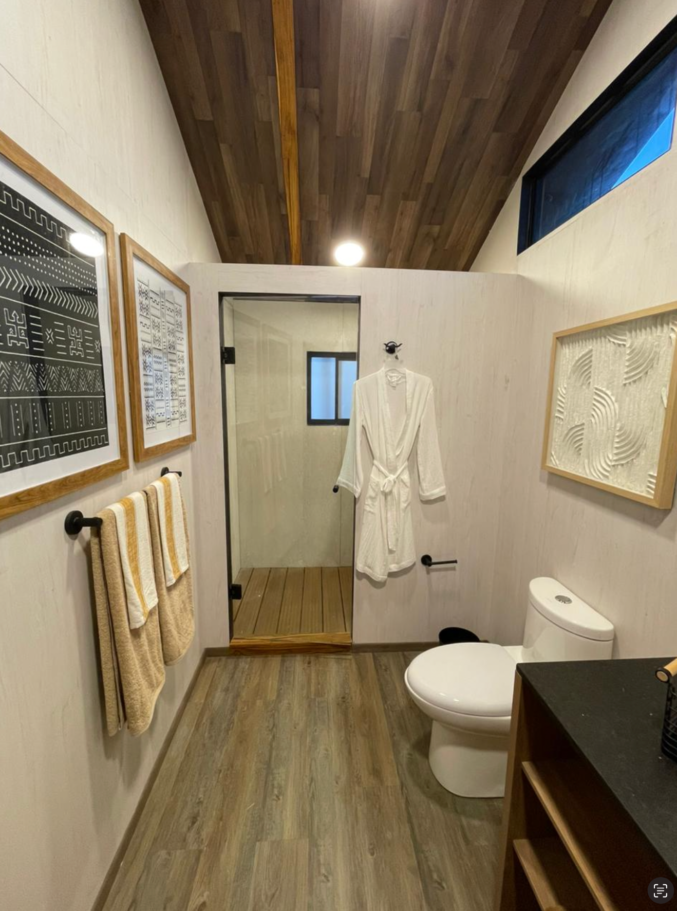 A bathroom with a toilet , sink , and shower.