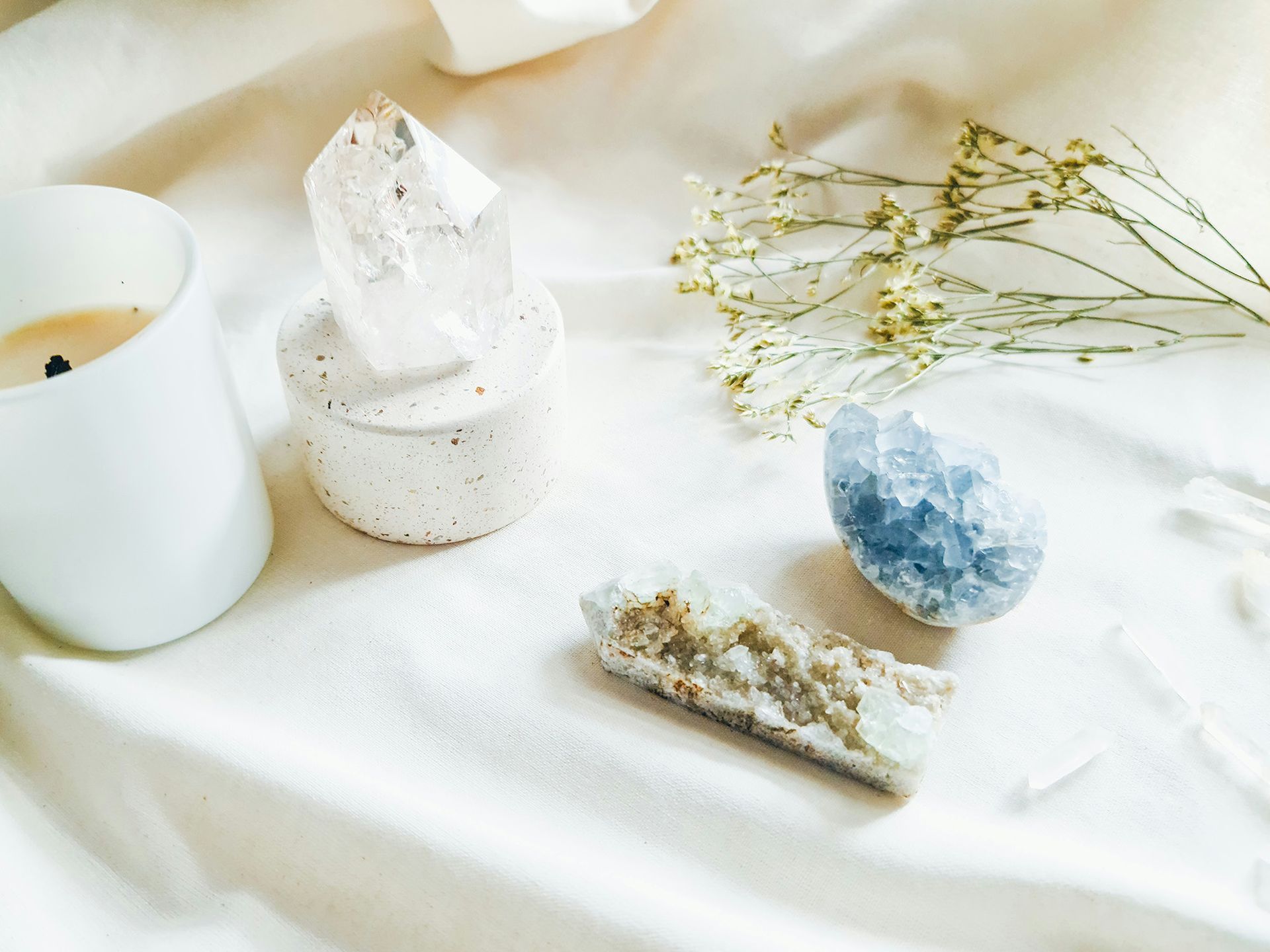 A bottle of palo santo next to a mortar and pestle on a table.