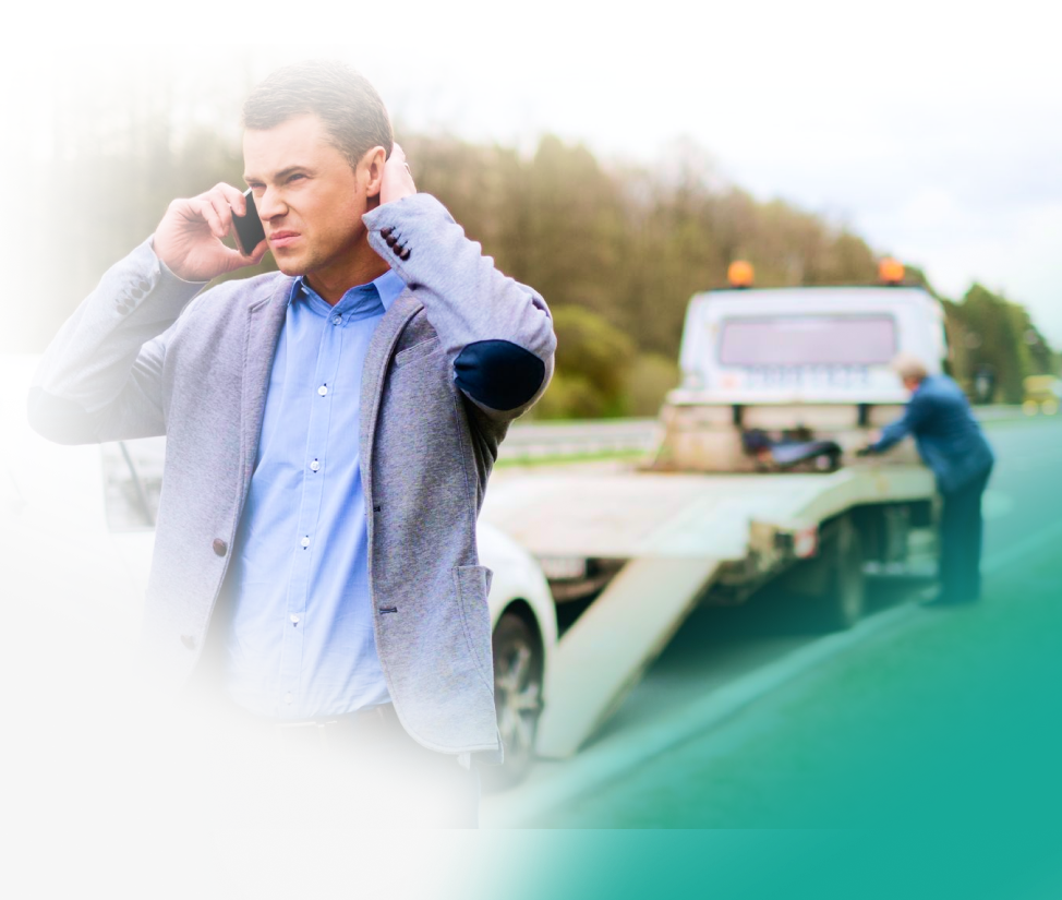 Mechanic examining engine of silver car on roadside with open hood. | Chicago Cheap Tows