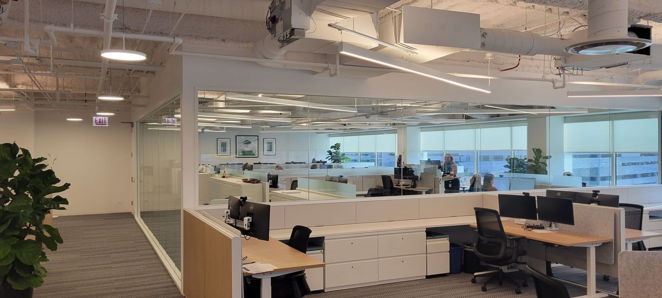 A large office with a lot of desks and chairs.