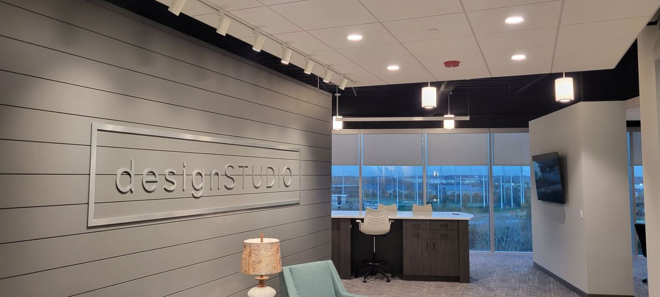 A room with a sign on the wall that says ' design ' on it.