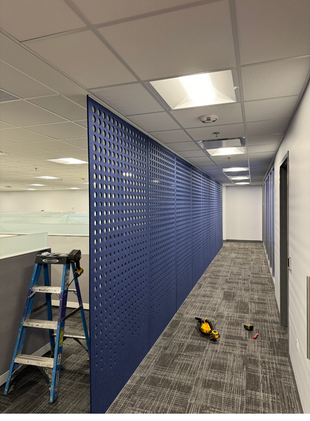 A long hallway with blue walls and a ladder