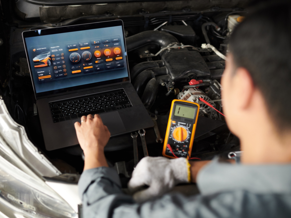 A man is looking under the hood of a car while holding a clipboard.